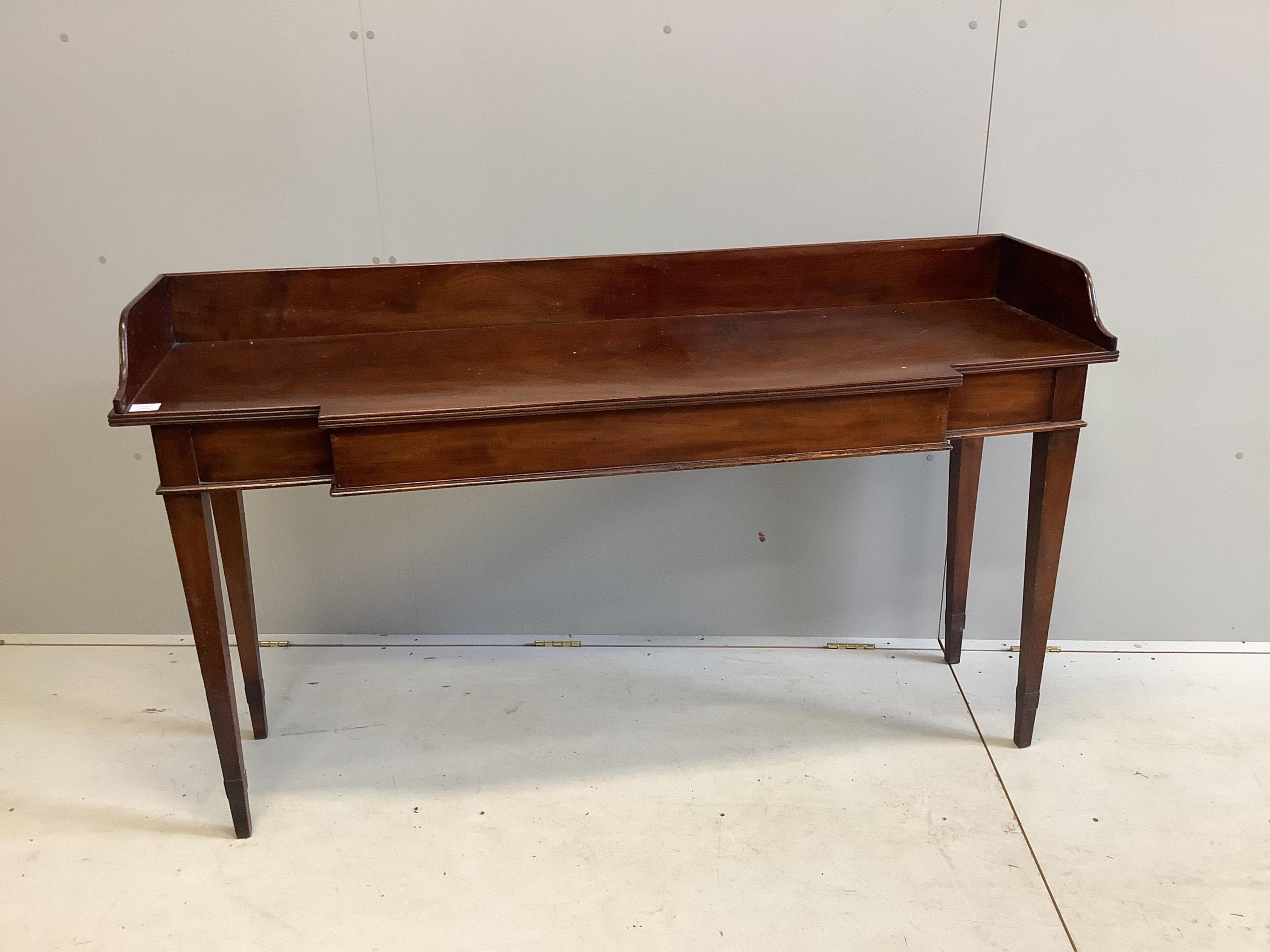 A George III mahogany breakfront serving table, with a three quarter galleried top, width 162cm, depth 48cm, height 93cm. Condition - fair